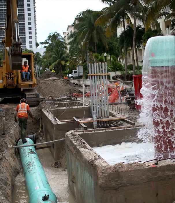 Construction workers installing infrastructure pipes